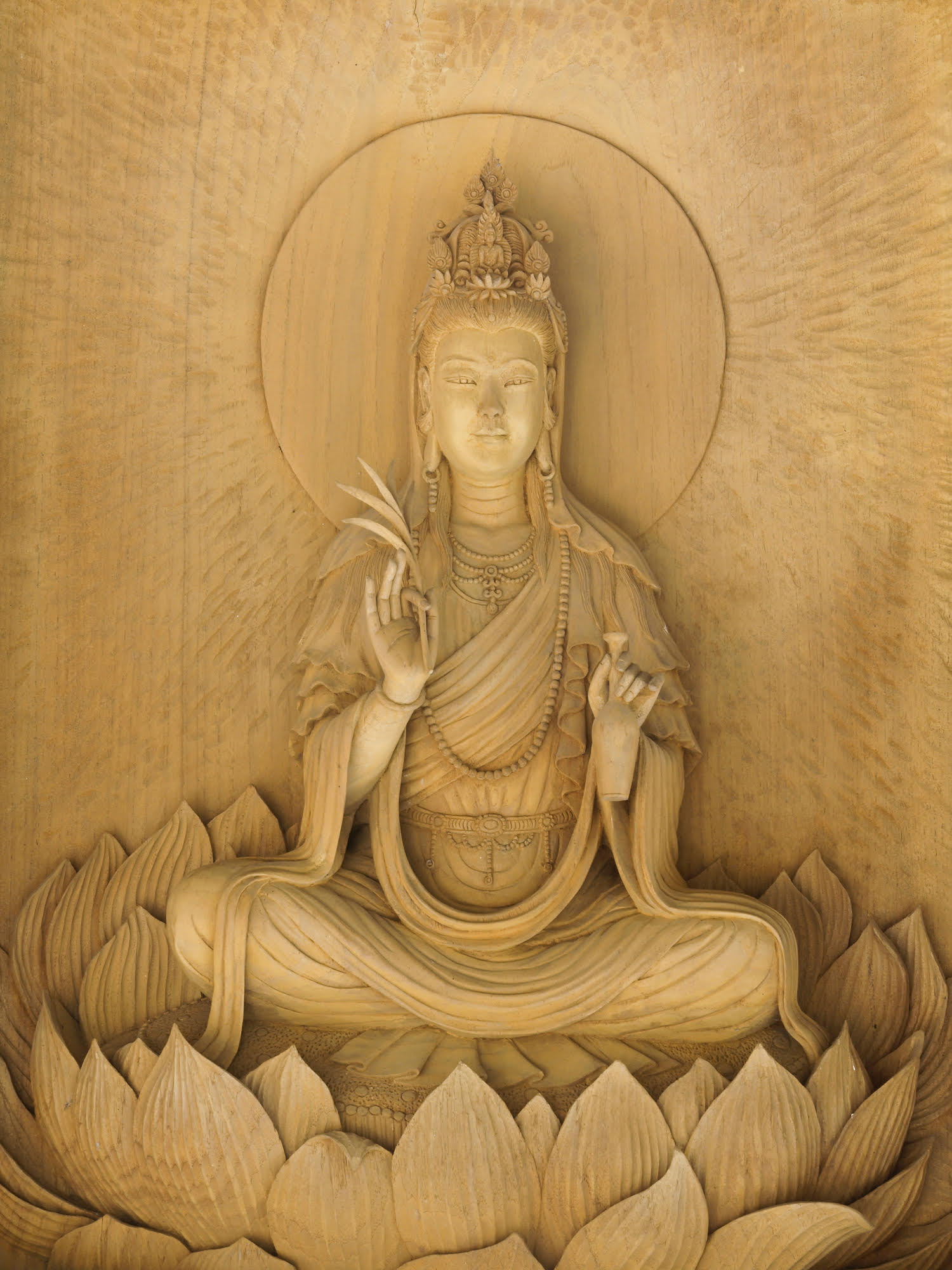 Kuan Yin image of buddha , Wood carving in a thai temple.